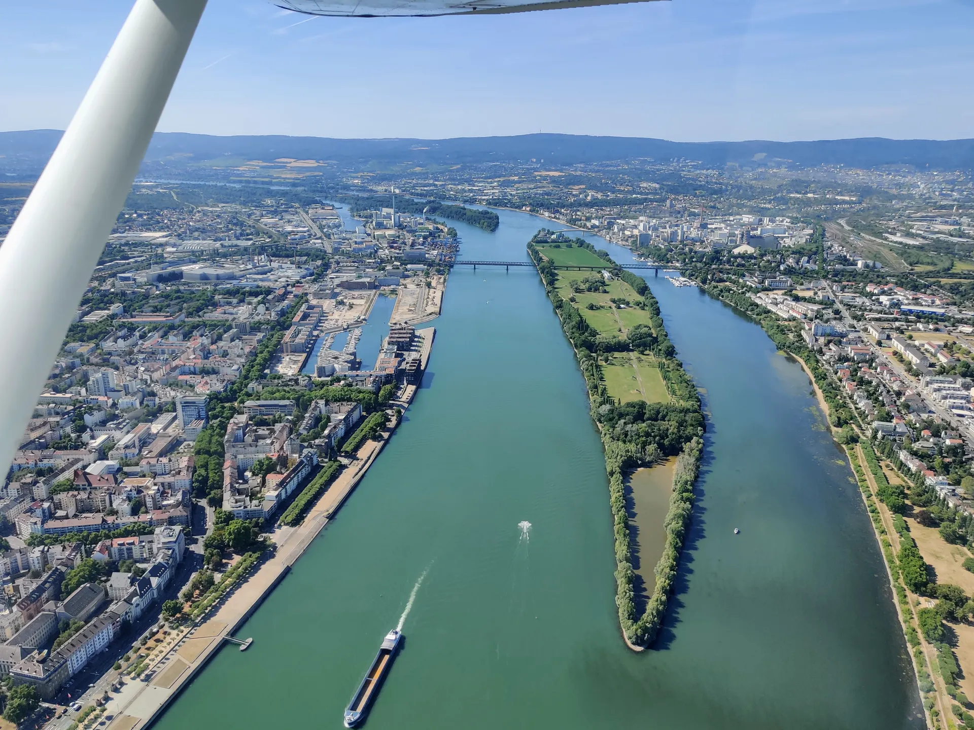 Aerial view from a small aircraft of the Rhine winding past Mainz with its river islands and skyline